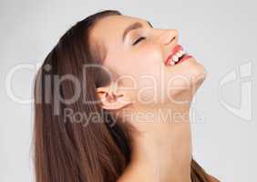 Laughter is good for your skin. Studio shot of a beautiful young woman posing against a grey background.