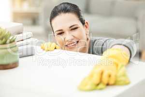 Spring cleaning, chores and sanitize for a clean, hygiene and fresh home while doing housework. Happy woman, cleaner and housekeeper wiping to disinfect a surface during routine household task