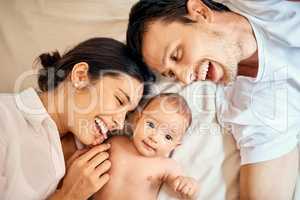 Its no wonder they made a beautiful baby. High angle shot of a happy mother and father bonding with their baby boy at home.