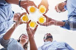 The week is done, time to chill and have fun. Low angle shot of businesspeople having drinks on their office balcony.