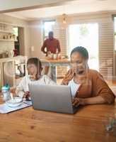 Busy, serious and multitask mother working on laptop while taking care of her child at home. Black entrepreneur or freelancer analyzing online reports with her and cute son playing games on a phone