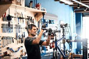 Hell repair your bike in no time at all. a man working in a bicycle repair shop.