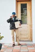 Hi, I am here with your delivery. a courier talking on a cellphone while making a delivery.
