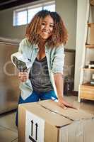 All packed and ready to store away. Portrait of a cheerful young woman taping a box closed to put it away in storage after moving into a new home.