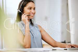 Call center agent, business consultant or telemarketer assisting client online using headset while typing at computer desk. Contact us for excellent customer service or online faq helpdesk support.