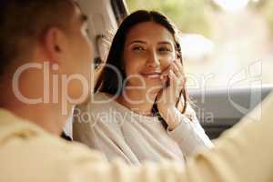 Happy, in love and smiling woman on road trip staring at her charming, caring and romantic husband in a car. Couple in a loving relationship traveling on holiday, getaway and honeymoon together