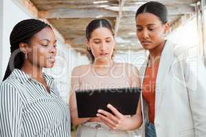 Collaboration, teamwork and working team with a tablet looking at digital data together. Group of female business office workers thinking and reading online web information planning a project outside