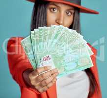 Rich, wealthy and stylish woman showing her money and success in fashion posing over copy space. Fashionable female advertising a cash prize or lottery win from a competition