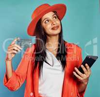 Credit card, online shopping and trendy woman with style typing in banking information to use a money service. Fashionable, stylish and edgy shopper thinking of buying modern clothes and new styles