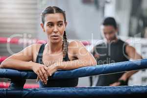 Fit, active and tired boxer taking break, resting and breathing after workout, training and exercise with boxing coach in ring. Sporty, athletic or strong woman after kickboxing fight or sports match
