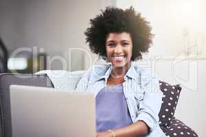 I prefer to browse at leisure. a young woman using a laptop on the sofa at home.