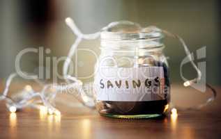 Finance, investment and future planning with a collection of many coins, money in a jar on a table. Retirement fund or growth profit, budget, saving for financial security. Banking on a tax returns