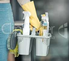 Domestic worker, maid or cleaner hands holding or carrying cleaning products and equipment or supplies. For home hygiene, contact us for a handy helper agency or professional household service.