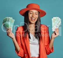 Money, currency and winning the lottery with a young woman holding cash and looking happy, excited and celebrating success. Female cheering with income, savings or a return on investment in her hands