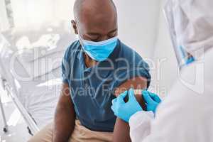 Man getting covid vaccine, bandaid for protection and control of virus with a medical doctor at hospital. Expert, professional or healthcare worker helping patient, doing checkup and giving injection