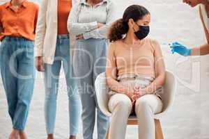 Covid vaccination, virus and vaccine needle flu shot with people in line at clinic facility for protection, or prevention of diseases. Woman wearing face mask for medical corona virus treatment