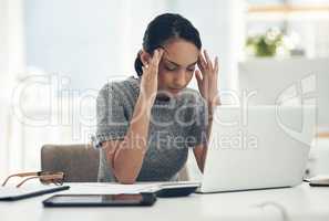 Headache, tired and stressed young businesswoman with financial problems on laptop sitting at desk. Professional female accountant in accounting finance and corporate business doing taxes and debt.