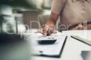 Accountant, finance and business woman calculating a budget or expense in her office. Closeup of a financial advisor planning tax payment, savings or investment for a company using a calculator