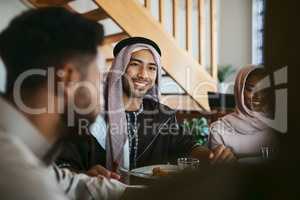 Muslim, arab and islamic man enjoying a meal for eid, ramadan or breaking fast with family while celebrating religion, holy culture and islam faith. Happy, smiling and spiritual guy eating lunch