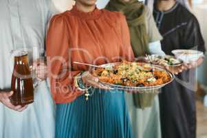 Ramadan, Eid and iftar with a muslim family holding food and drink to break their fast at home together. Closeup of rice and curry in the hands of a woman with people holding other meals and juice