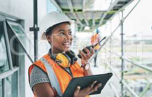 Construction worker with tablet, walkie talkie or radio talking, instructing and checking building progress on development site. Architect manager, female leader or engineer watching infrastructure