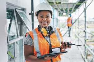 Portrait of proud black construction worker leading with power while managing site logistics on tablet. Happy female engineer supervising a building project and inspection of architectural details