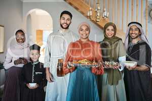 Portrait of a happy, smiling and positive muslim family celebrating Ramadan together, spending the day embracing religious holiday. Islamic siblings gathering for lunch in their family house