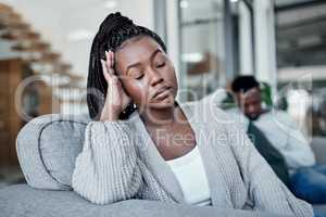 Sad, frustrated and tired woman ignoring husband during a fight, argument and conflict about divorce, breakup and relationship problems. Unhappy, stressed and depressed wife feeling sad in a marriage