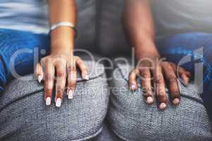 We touch each others lives in great ways. Closeup shot of an unrecognizable couple with their hands alongside each other on a couch.