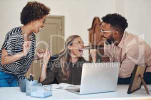 Happy, smiling and cheering young university or college students excited after completing a project. Casual team of learners celebrating after getting a good grade on a their research assignment