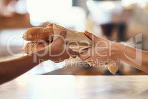 Customer buying bread from bakery, purchasing baked goods and shopping for food at a shop. Hands of female client and employee giving service, taking product and helping with item at grocery store
