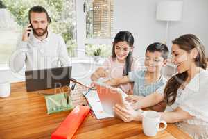 Kids education, learning and fun activity with mother teaching on tablet at home and father doing remote work in background. A multimedia, modern family enjoying online app or web with internet wifi