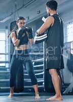Boxing woman training in gym with trainer for better fitness, wellness and health. Active and young female client doing punching and kickboxing workout or exercise with personal coach in sportswear