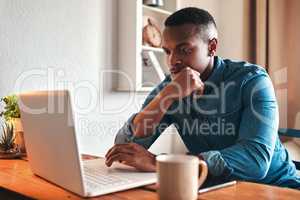 Man thinking, typing and working on a laptop remote for a social media startup content writing business. Planning, focused and serious freelancer, writer or author reading and reviewing an article