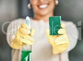 Cleaning, hygiene and sanitation with a spray bottle and sponge in the hands of a woman wearing gloves. Closeup of chores, housework and a spring clean to keep things neat, tidy and fresh