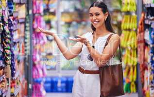 Customer, shopper and consumer advertising, pointing and marketing brand of product, stock and grocery to buy for shopping in supermarket store. Happy woman recommending and endorsing in retail shop