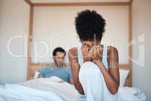 Woman crying after fighting with husband in bedroom at home. Wife sad after husbands affair, lies and cheating in the bed. Depressed couple having relationship problems and decide to get a divorce