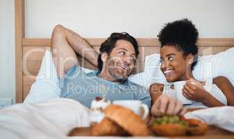 Valentines surprise, birthday or interracial couple celebrate womens day breakfast in bed by a romantic, husband for his wife together. Sweet, in love and loving man serving his lady food and bonding