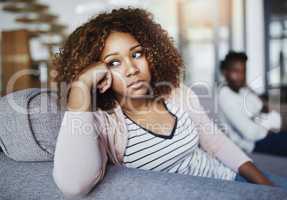 Relationship issues, communication problems and divorce talk of a couple after a fight at home. Upset female feeling frustrated on a living room couch. Annoyed couple on a sitting on a sofa