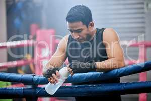 Sad, lose and defeated athlete looking tired after workout, unhappy and drinking water after boxing for fitness. Young, sporty and Asian man breathing heavily, resting and taking break from exercise