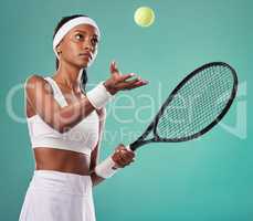 Professional tennis player, sports woman isolated holding a racket ready for a game. Sporty, active and healthy athlete preparing for a serious sport competition or tournament on studio background.