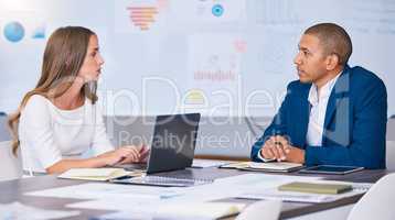 Collaboration, teamwork and planning team of social media marketing and advertising professionals talking in strategy meeting. A man and woman working on a messy office, workstation or workplace desk