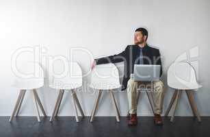 Contemplating ways to get the job. Studio shot of a businessman waiting in line against a white background.