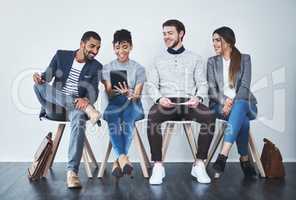 Sharing some inspiration with everyone else. Full length shot of a group of young businesspeople waiting in line for a job interview.