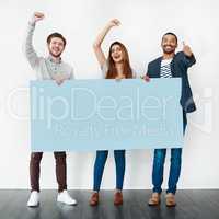 Giving the youth a voice. Studio shot of a diverse group of young people holding a blank placard and cheering against a white background.