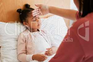 Sick child with mother checking forehead temperature, feeling ill and unwell. Small girl with illness, fever or disease at home in bed resting, sleeping and recover from infection, flu or covid virus