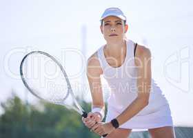 Tennis, sport and serious woman holding her racket and ready to play on court outside. Determined and sporty female playing in professional sports competition. Enjoying active hobby during free time