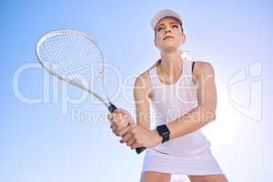 Professional tennis player, fit athlete and active woman playing sport, match and game with racket outdoors from below. Competitive, determined and serious female ready to serve, hit and play