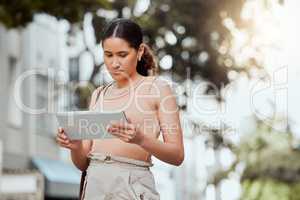Reading, checking or browsing social media on tablet while out commuting through city and looking for directions or inspiration online. Young entrepreneur using business website tool for ideas