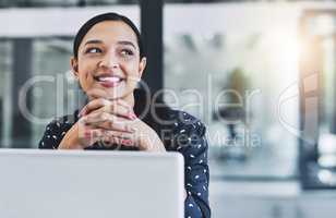 Contemplating business plans. an attractive young businesswoman in her office.